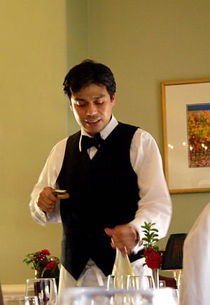 Sommelier pulling the cork from a bottle of wine